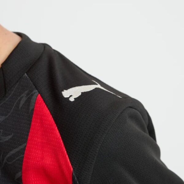 AC Milan youth home football jersey 2025/26, black and red design, official team kit for young fans.