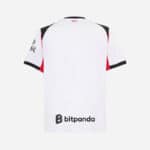 Football jersey with black, white, and red accents, featuring sponsor logos, ideal for soccer enthus.