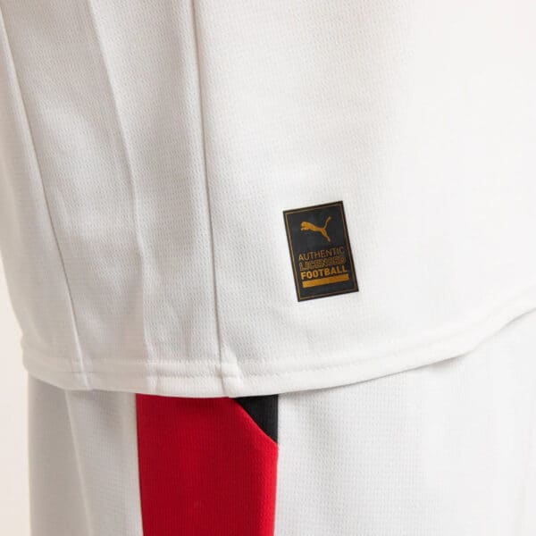 Close-up of authentic Puma football jersey with official badge.