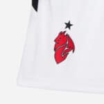 Football club logo featuring a red dragon and black star on white sports jersey.
