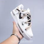 Nike Air Force Low 1 in white with beige accents, stylish casual footwear.