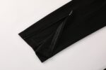 Black Nike Dri-Fit tracksuit pants with zippered ankle cuffs for athletic comfort.