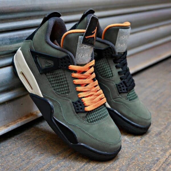 Authentic Air Jordan 4 Retro Undefeated sneakers in green and black with orange accents.