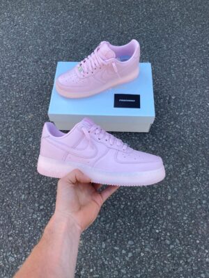 Air Force Low 1 NOCTA pink sneakers with Nike branding.