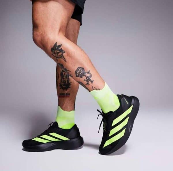 Adidas Adizero Evo SL running shoes in black with neon yellow accents.