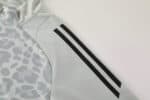 Leopard camo Adidas track suit in light grey with blue stripe accents, perfect for sports and casual.