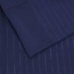 Men's Scotland football home jersey 2025 by Macron, navy blue with subtle pattern.