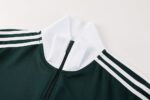Dark green Adidas sports jacket with white stripes, full zipper, and comfortable fit. Perfect for tr.