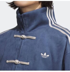 Unisex dark blue adidas casual jacket with white stripes and toggle closures.