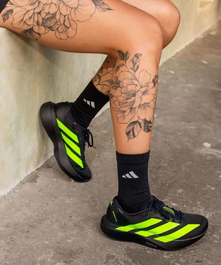 Adidas Adizero Evo SL running shoes in black with neon yellow accents. Lightweight, high-performance.