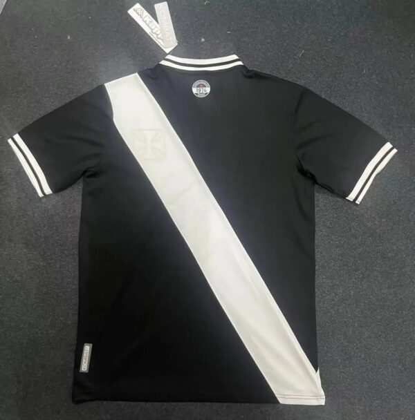 Black and white football jersey with diagonal stripe, short sleeves, and team logo for sports fans.