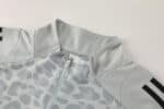 Leopard camo light grey Adidas track suit with blue stripes, perfect for sports and casual wear.