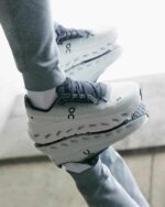 Athletic Cloudtilt trainers in black and ivory for optimal comfort and style. Perfect for sports and.