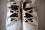 Air Force Low 1 white sneakers with light beige accents and black laces.