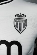 Monaco FC third kit 2024/25 with crest and design details.