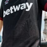 Football jersey with Betway sponsor logo and Umbro branding, close-up view.