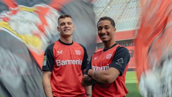 Bayer Leverkusen 2024/25 home football jersey with team logo and vibrant red design.