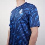Real Madrid blue football jersey with flame pattern, official club crest, and Nike logo.