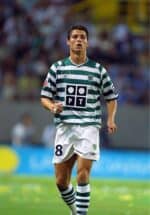 Ronaldo wearing Sporting Lisbon 01/02 home jersey with green and white stripes, number 8, on a footb.