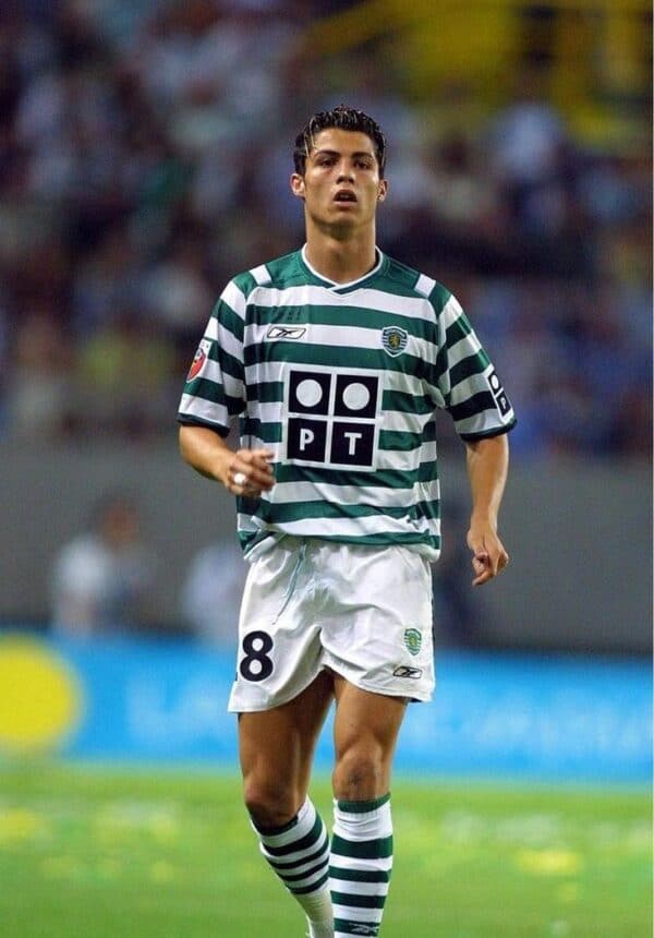 Ronaldo wearing Sporting Lisbon 01/02 home jersey with green and white stripes, number 8, on a footb.