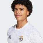 Authentic Real Madrid white football jersey with Adidas logo and club crest, perfect for fans and pl.