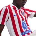 Authentic Atlético Madrid football jersey for 2025/26 season. Red and white vertical stripes, club c.
