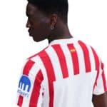 Atlético Madrid 2025/26 home football jersey with red and white vertical stripes, featuring club log.