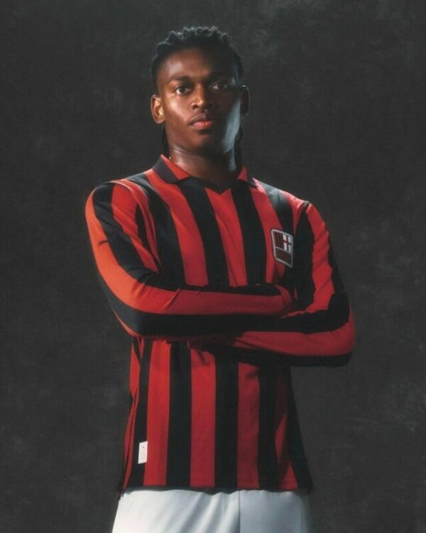 Soccer jersey featuring bold red and black vertical stripes, team crest, and athletic fit for footba.