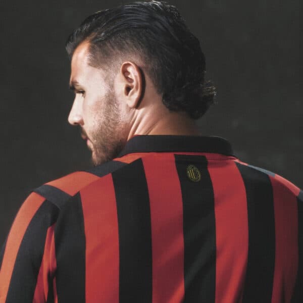 Football jersey with red and black vertical stripes, back view.