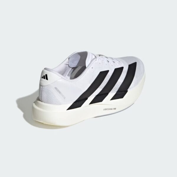 White Adidas running shoe angled to the side, showing the black three-stripe design against a pale gray background.