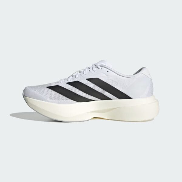 Close-up of a white running shoe with three black stripes on a pale gray background.