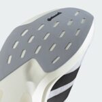 Close-up of a grey metallic iron soleplate with evenly spaced rectangular vent holes and a smooth brushed surface, angled across the frame.