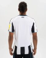 Newcastle United 2025/26 home football jersey, white with black stripes, for fans and players.