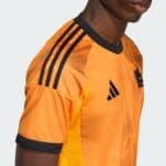 Roma Away Jersey 2025/26 in vibrant orange with black accents, perfect for football fans.