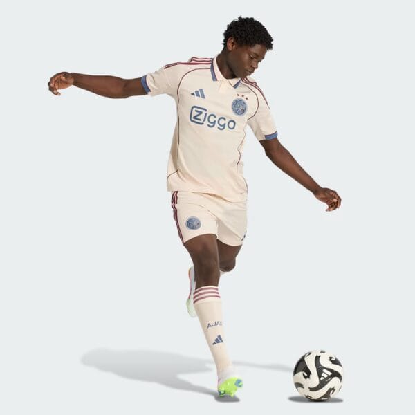 AJX Third Jersey 2025/26 with player in action, showcasing authentic football kit.