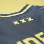 AJX Away jersey 2024/25 with yellow accents and premium fabric for football fans.