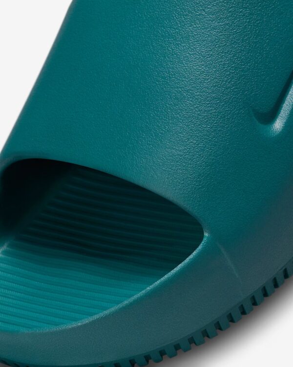Comfortable teal slide sandal for casual wear. Perfect for summer, featuring a textured footbed and.