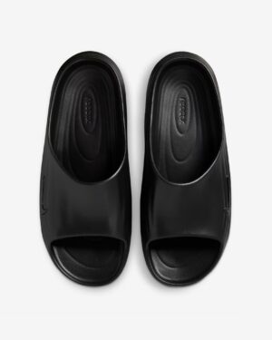 Pair of black slip-on slide sandals viewed from above, showing glossy uppers and grooved footbeds with brand text inside each shoe, on a light background.