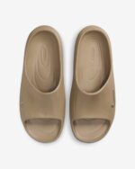 Pair of tan slide-on sandals seen from above, with roomy toe openings and smooth matte finish.