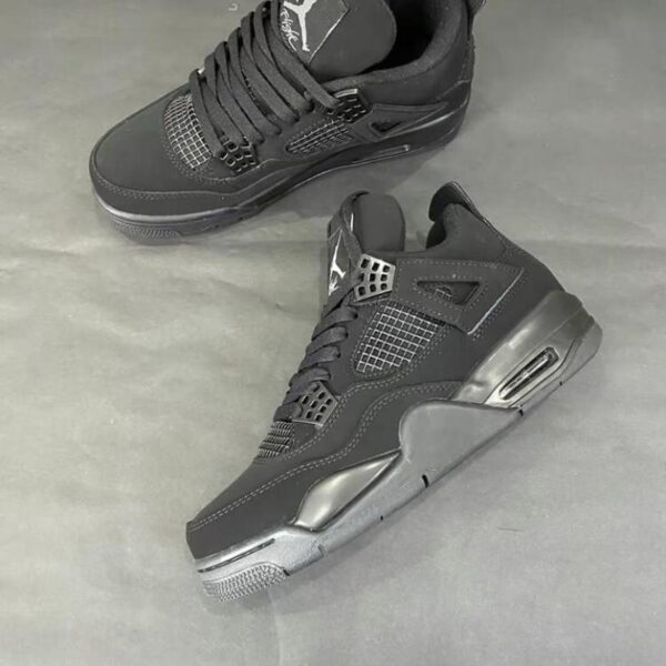 Black Air Jordan 4 sneakers with sleek design and air cushioning.