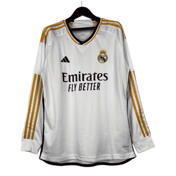 Authentic Real Madrid white football jersey with gold details and club crest, perfect for fans and p.