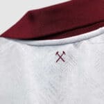 Football jersey with collar and logo detail, perfect for sports fans and athletes.
