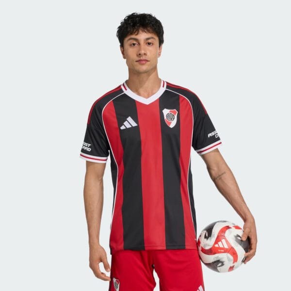 River Plate away football jersey 2025/26 with red and black stripes, official club logo, and Adidas.