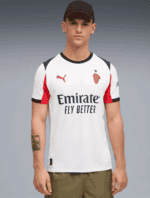 Men's soccer jersey with lion crest, Puma logo, and Emirates sponsor.