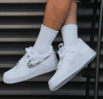 Air Jordan Air Force Low 1 Molten Metal white sneakers with metallic swoosh.