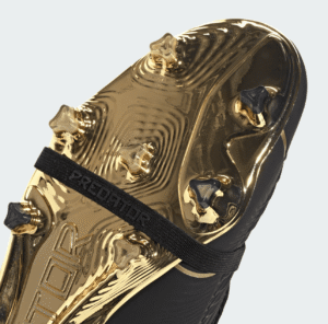 Premium gold and black Adidas Predator football boots for firm ground play.