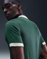 Wolfsburg 80th Anniversary football jersey, green with white accents, celebrating club history.