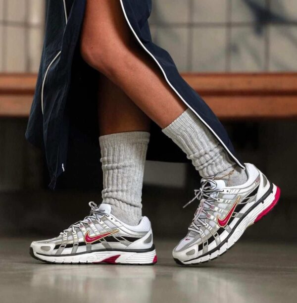 Nike P-6000 sneakers in white, gold, and red with sleek design.