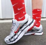Nike P-6000 white, gold, and red athletic sneakers for men and women.