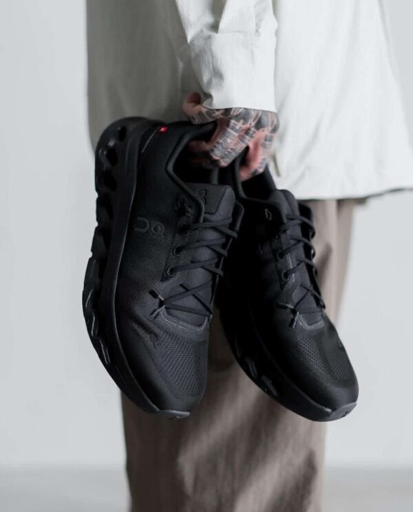 Black On Cloudtilt "Triple Black" running shoes for men and women.